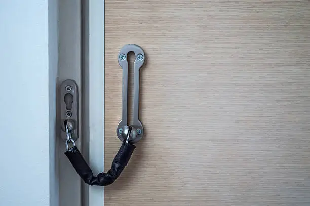 A door chain used to keep the door of a home secure. It allows for the door to be opened at a set amount to see who is on the other side.