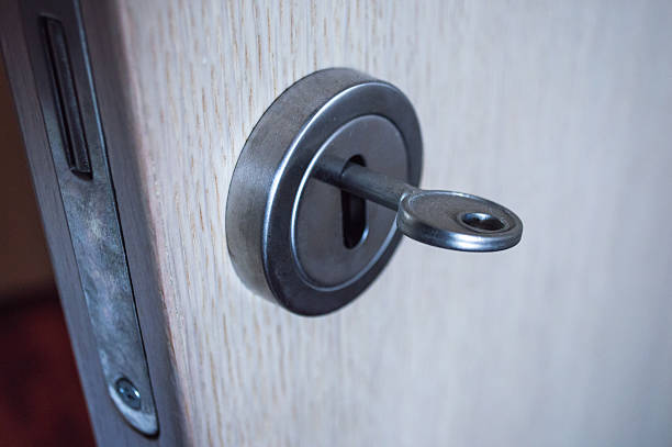 istock Lock and Key on an Open Wooden Door Close Up 545555208