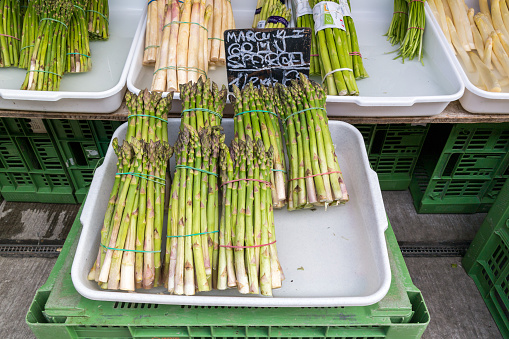 Vienna, Austria - May 23, 2016: Bundles of fresh asparagus displayed in market stand on Naschmarkt in Vienna, Austria