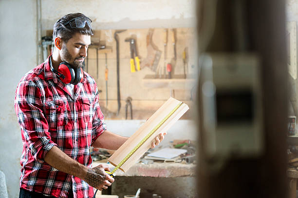 istock Male carpenter measuring the board 545555884