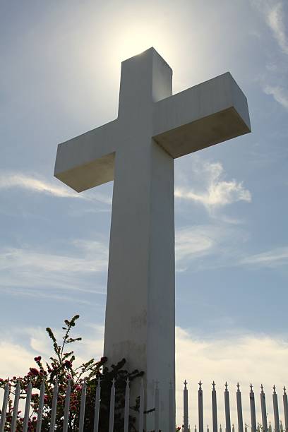 istock Large Cross Silhouetted Against The Sun 545558076