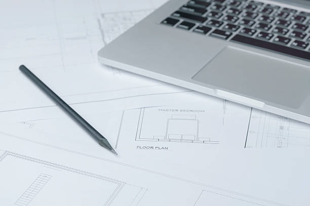 istock black pencil and computer laptop on architectural drawing paper 545558428