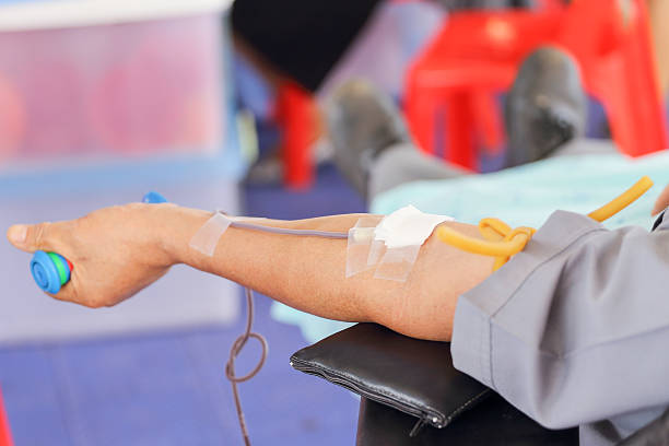 arm of a donor donating blood at hemotransfusion station stock photo