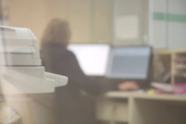 istock View through window of woman working in office 545559224