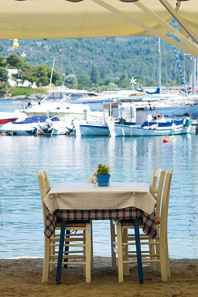 istock Restaurant on the beach with blurred boats in the background 545559908