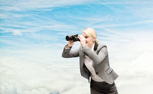istock Smiling businesswoman searching with binocular 545561496