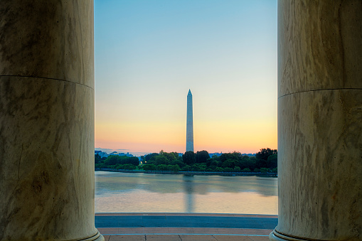Morning view of the Washington Monument framed between two pillars of the Jefferson Memorial
