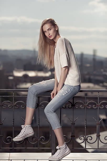 istock Fashion model. Summer look. Jeans, sneakers, sweater. 545565610
