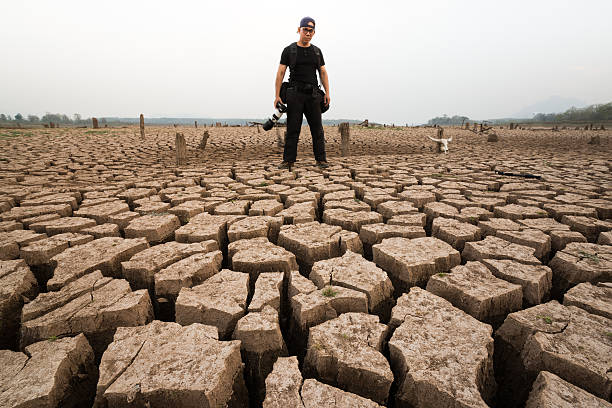 photographer stand in dry land stock photo