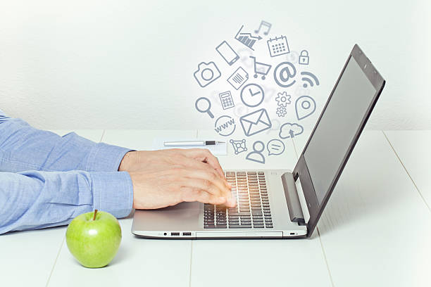 istock man working on laptop and media icons fly off 545568766
