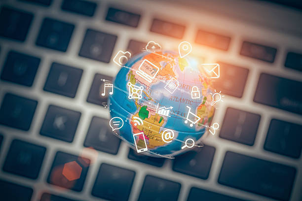 media icons fly off around globe on laptop