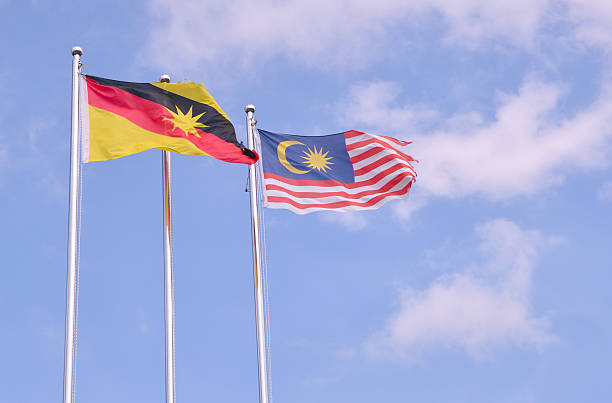 malaysian flag next to a sarawakian flag - sarawak state imagens e fotografias de stock