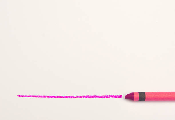 istock Magenta crayon drawing a line on white paper 545571016