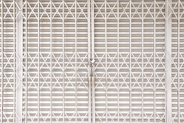 istock Closed shutters and metal accordion gate 545571122