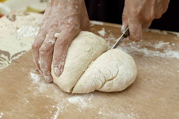 istock hands of the cook knife dough 545571334