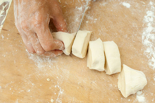 istock hands of the confectioner cut dough 545571782