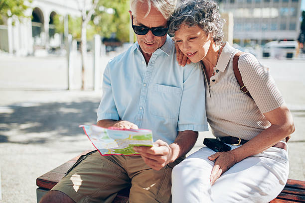 istock Senior couple looking for a destination on a city map 545574510
