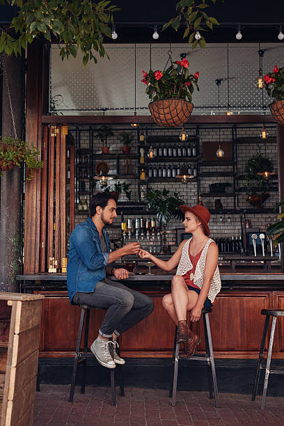 istock Couple sharing cigarette at coffee shop 545575600