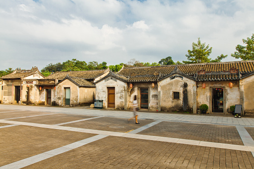 Traditional Chinese residential area with a walking woman at Shenzhen, Guangdaong, China