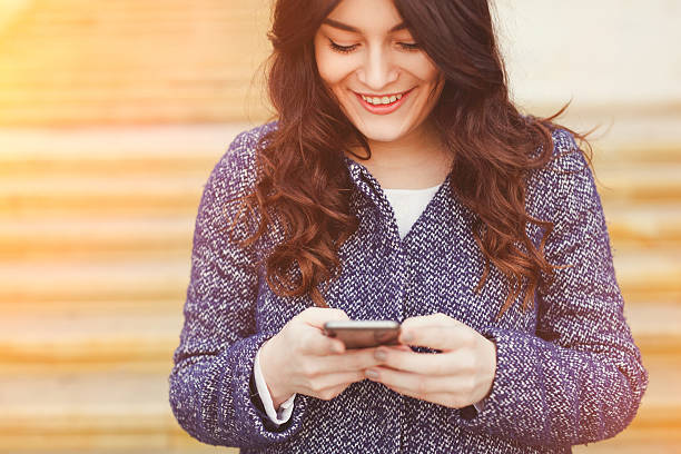 istock Caucasian woman female using cellphone smartphone while walking 545579868