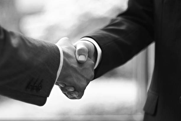 Shaking hands Men shaking hands monochrome stock pictures, royalty-free photos & images