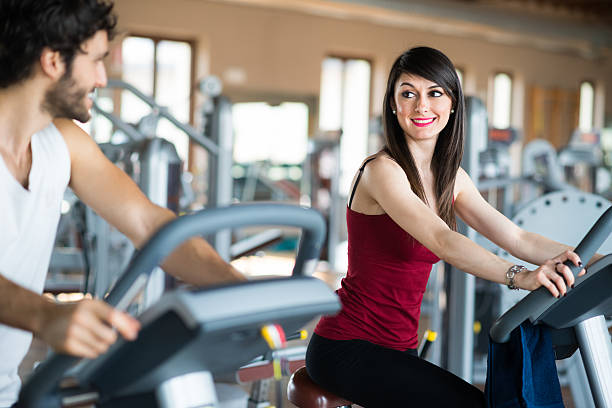 istock People working out on a stationary bike 545581428