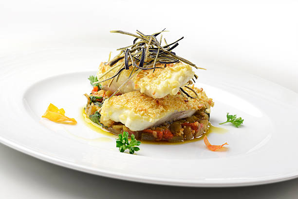 Fish dish, fillet of turbot in almond crust Fish dish, fillet of turbot in almond crust on chopped eggplant and stewed with eggplant chips turbot stock pictures, royalty-free photos & images