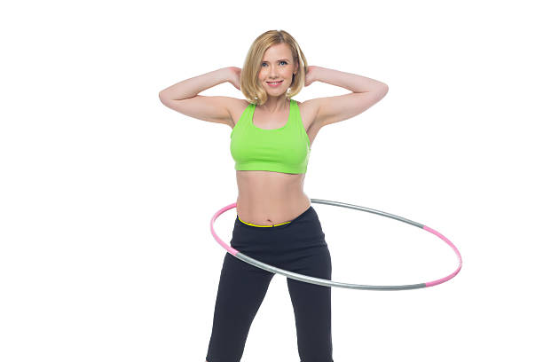 istock Beautiful woman doing sport exercise with hula hoop 545583856