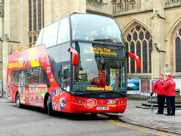 Bath, Somerset, UK. December 14, 2009.  A Bath city sightseeing bus waiting passengers with tour guides outside the Abbey.