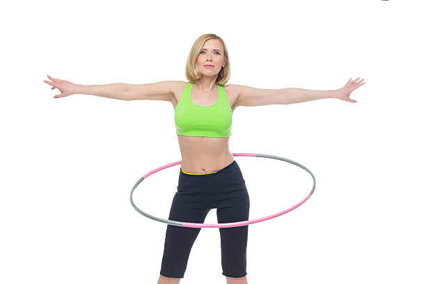istock Beautiful woman doing sport exercise with hula hoop 545583912
