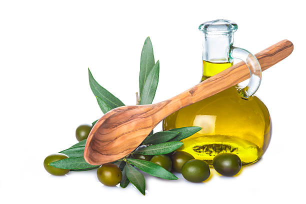 istock Olive oil bottle and wooden spoon isolated 545584414
