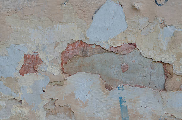 istock Gray plaster weathered wall with stains and cracks 545584504