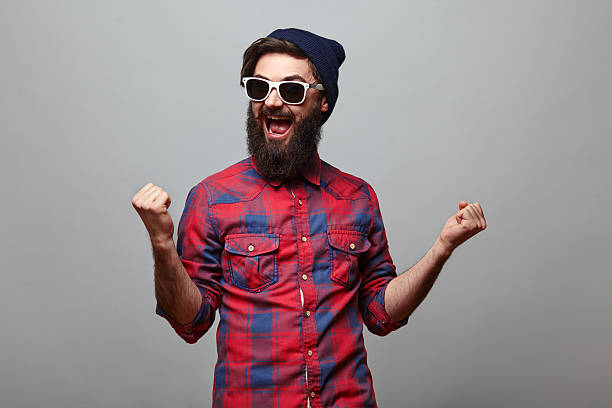 istock happy hipster man with beard exults 545584508