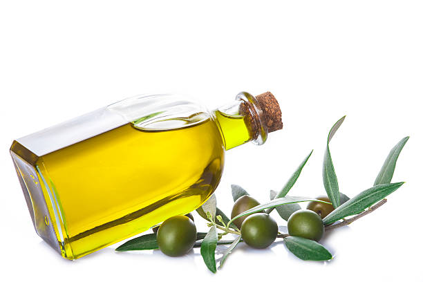 istock Olive oil bottle with leaves isolated on white background 545585546