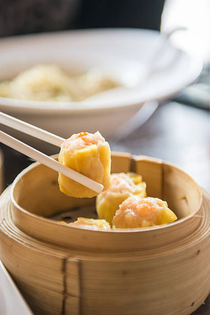istock chopstick hold dimsum from bamboo containers 545586360