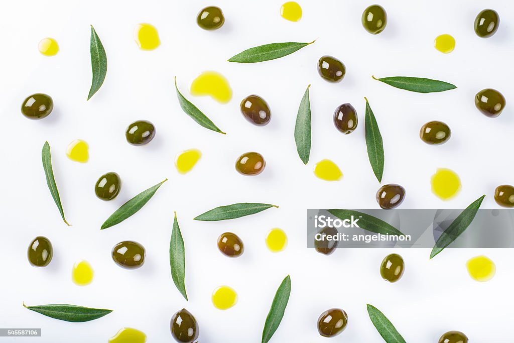 olives, leaves and  oil drops on a white background olives, leaves and  oil drops isolated on a white background Olive Oil Stock Photo