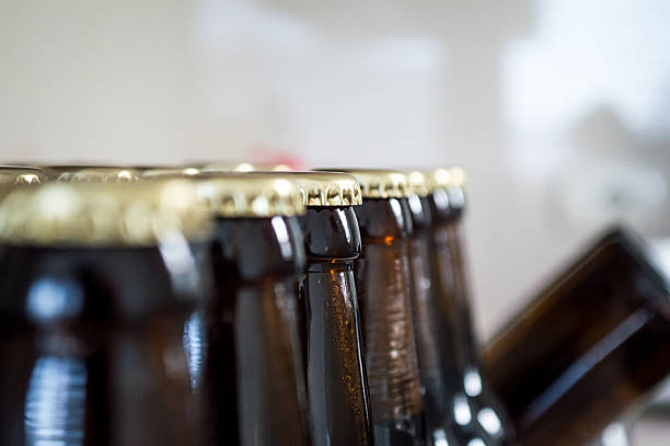 istock Brown Beer Bottles/Caps Lined Up Close Up 545588566