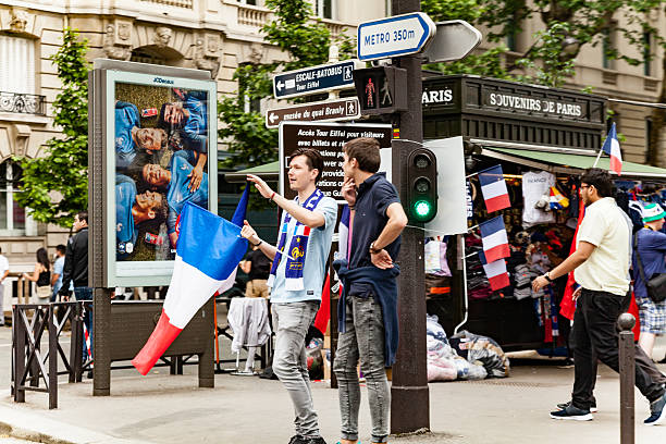 Paris, France - June 10, 2016: French football fan with tricolor french flag near the fan zone.