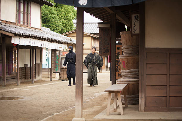 istock Ninja and Samurai masters walking down the village street 545589658