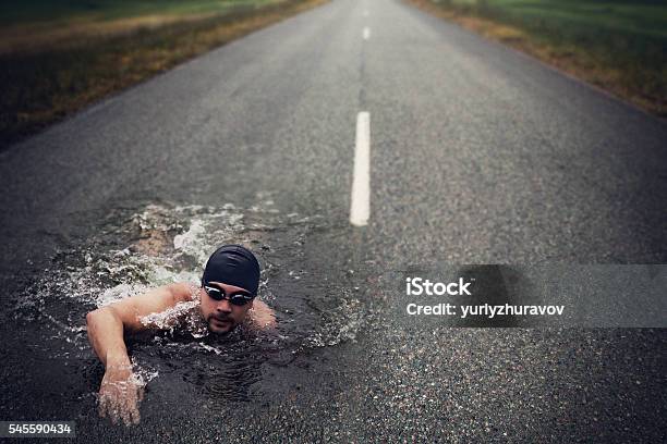 Strong Man Swim On Asphalt Road Stock Photo - Download Image Now - Bizarre, Conquering Adversity, Men