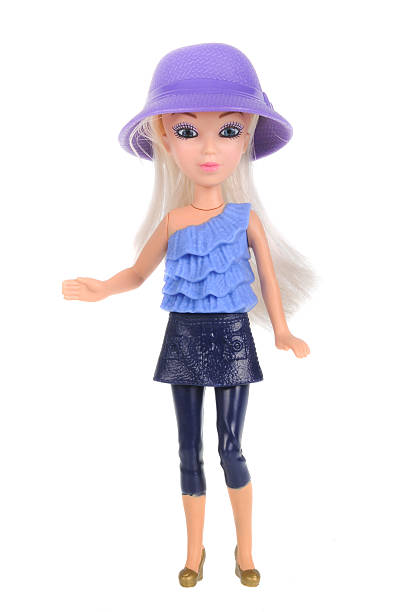 Amazing realistic vintage toy with blue eyes.The doll dressed in a blue dress and has a blond hair. Selective focus. Porcelain.