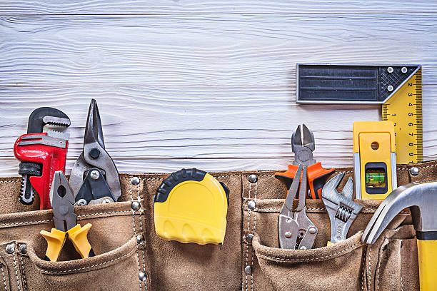 istock Building tooling in leather tool belt on wooden board top 545592216