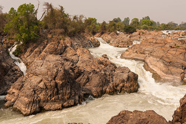 istock Raging water flowing down waterfall during rainy season showing 545592240