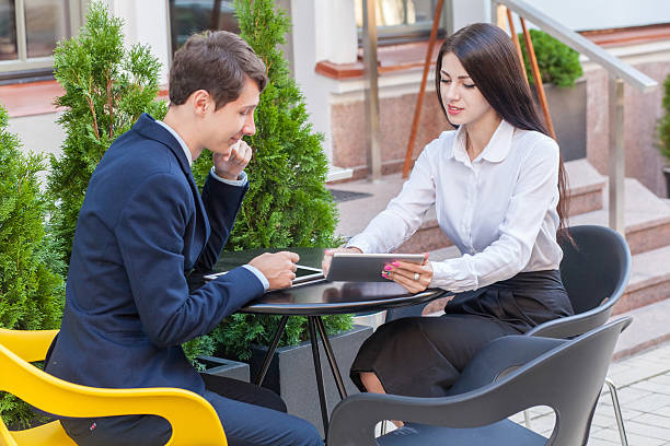 istock Two friends sitting in cafe and discussing their business. 545592420