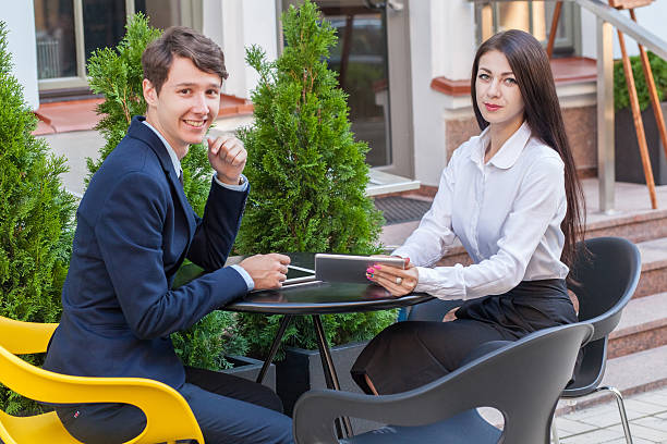 istock Two friends sitting in cafe and discussing their business. 545592528