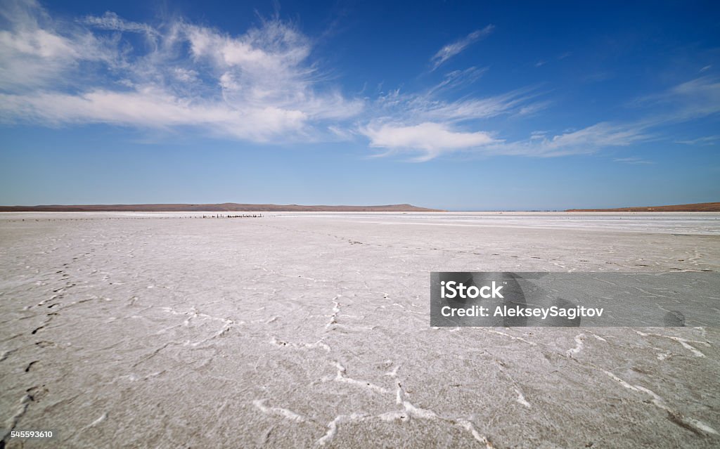 Dry lake under blue sky Dry lake under blue sky with clouds Backgrounds Stock Photo