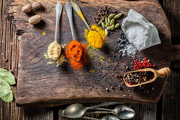 istock Fresh spices on spoon and herbs on old table 545593972