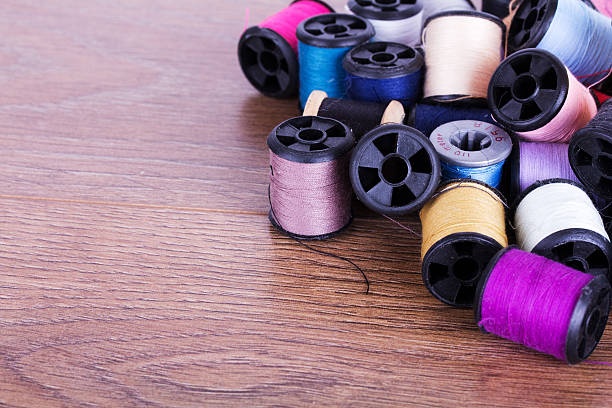 istock Scattered cotton reels on a wooden surface 545594274