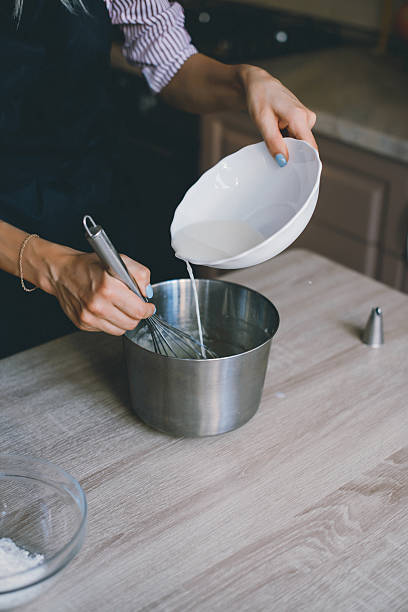 istock Young woman chef cooking cake in kitchen 545633908