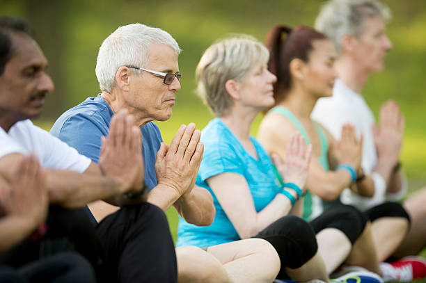 istock Meditating During an Outdoor Yoga Class 545634286